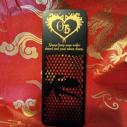 Exclusive metal bookmark with dragon in flight that reads "Always keep your scales shined and your talons sharp."